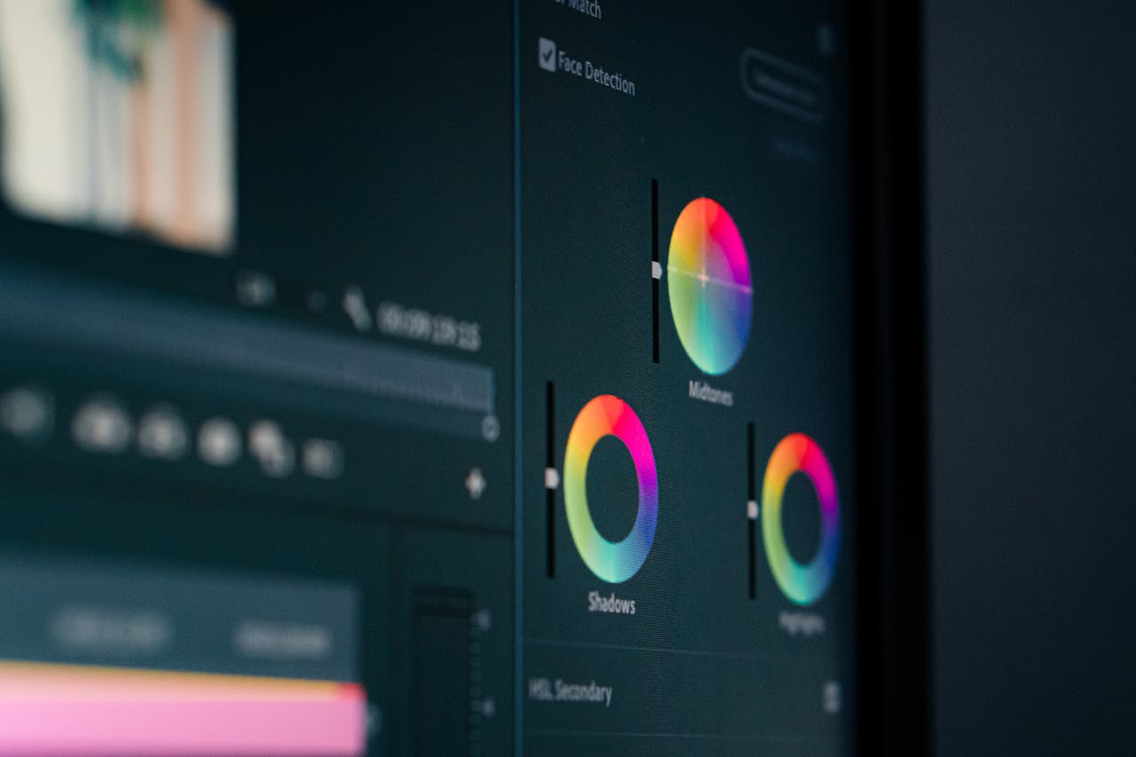 services-img Close-up of color grading wheels on a monitor, showcasing digital editing in vibrant hues.